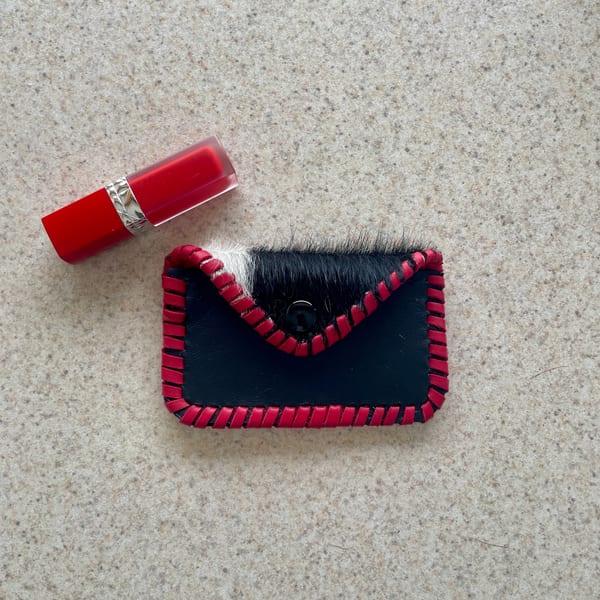 Embossed leather card sleeve with concho snap
