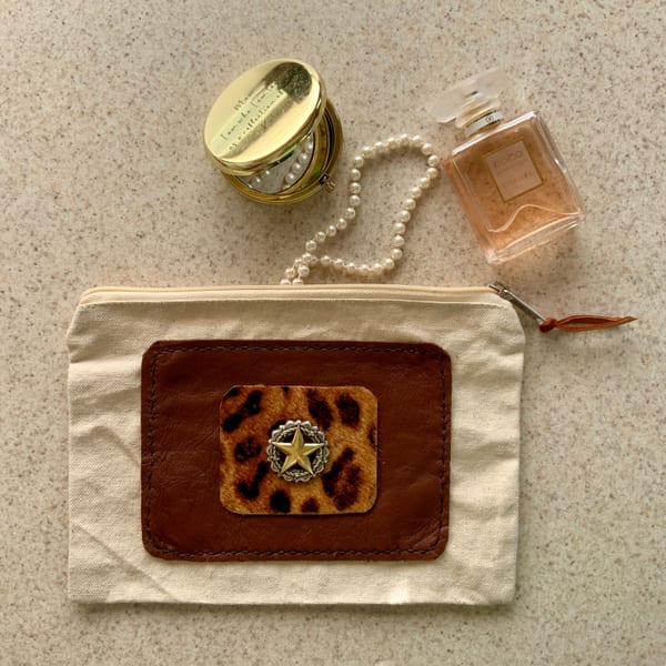 Leather zipper pouch with western concho detail